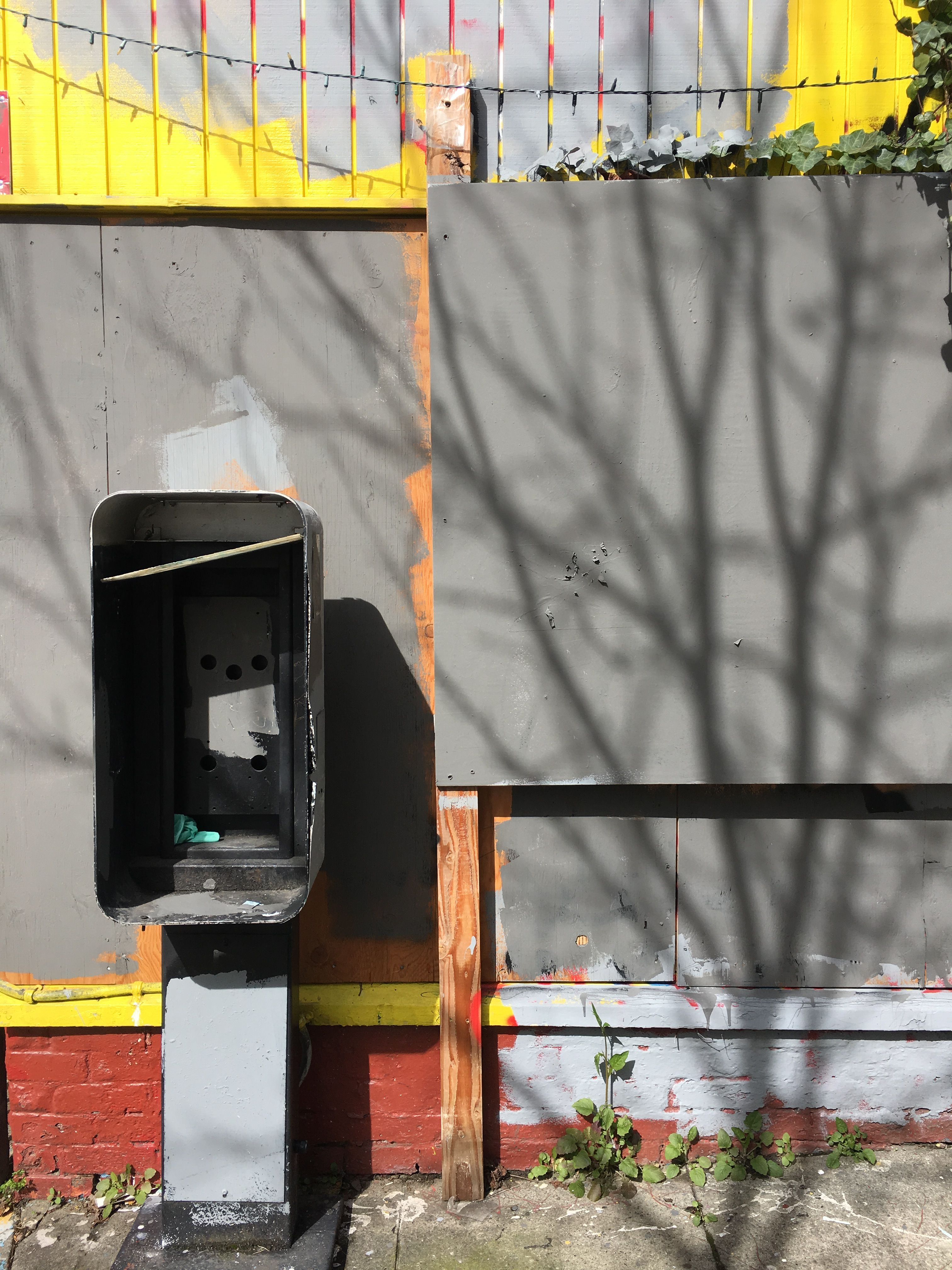 phoneless phone booth, tree shadow
